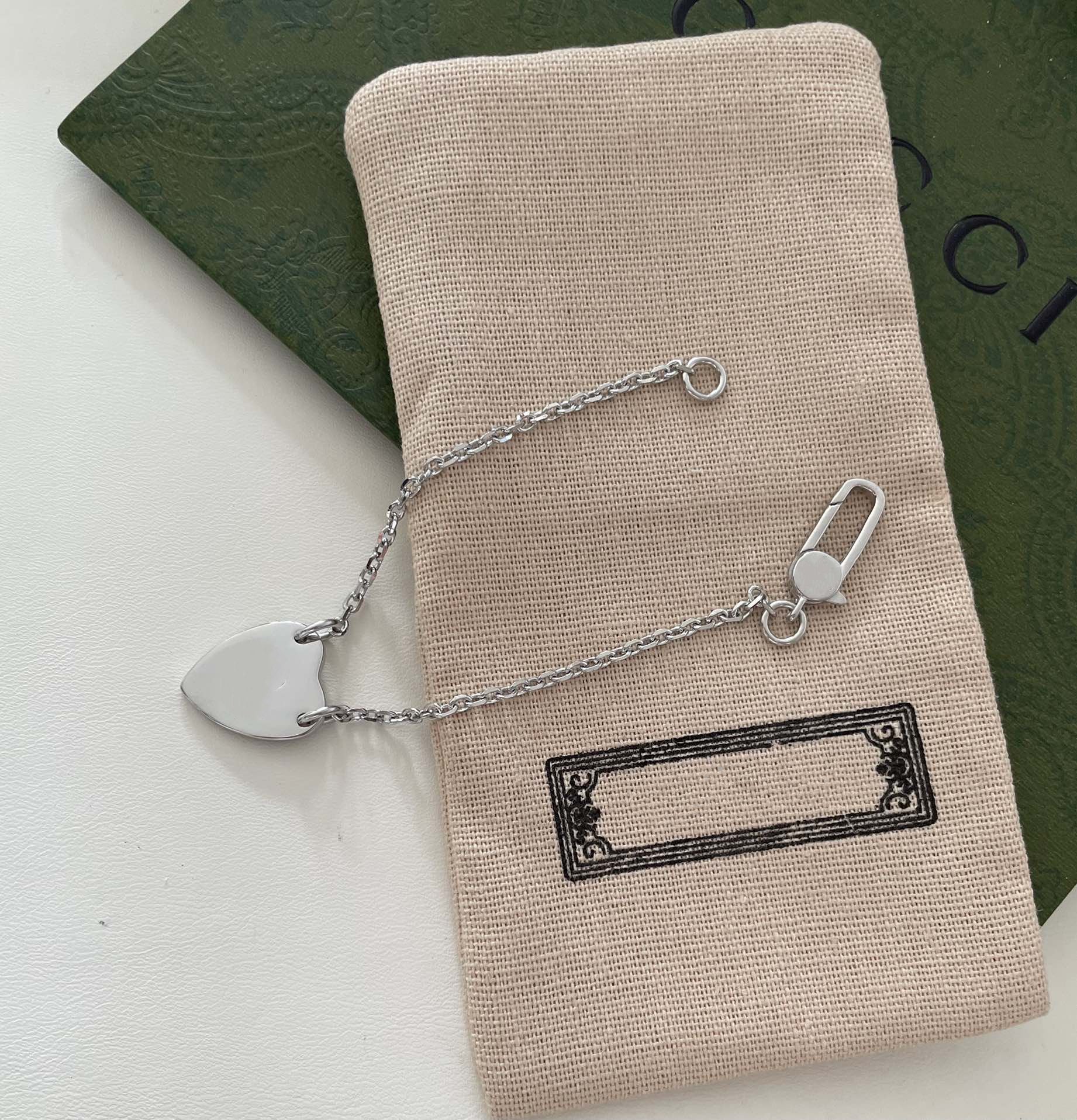 Gucci GG Logo Heart-Shaped Pendant Silver Bracelet